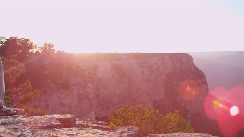 Lone female standing on the edge at sunset, Grand Canyon, USA, Shot on Red Epic