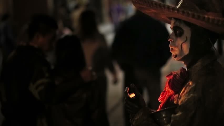 Artist with face painted like skull in Mexican Holiday Day of Dead