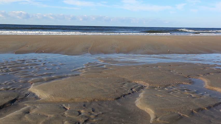 Morning seashore tidal pools (low angle view of morning tidal pools at a carolina beach)