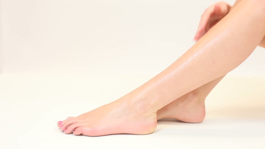 Blonde woman stroking smooth legs