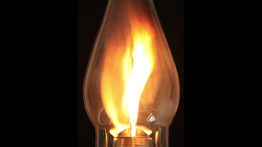 Close-up of a lamp bulb burning over a black background. Burns intensely in the beginning then decreases. Segments are easily loopable. 