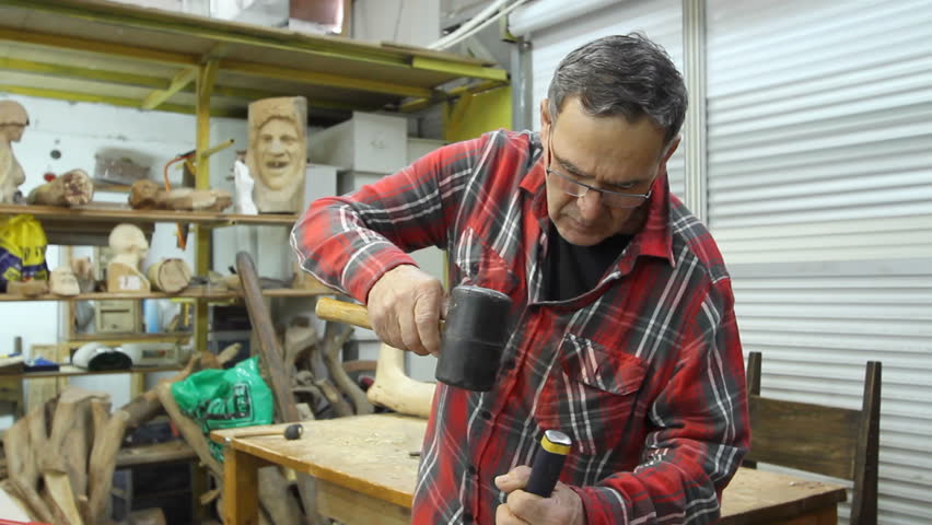 Wood carving tilt down from the artist to his work