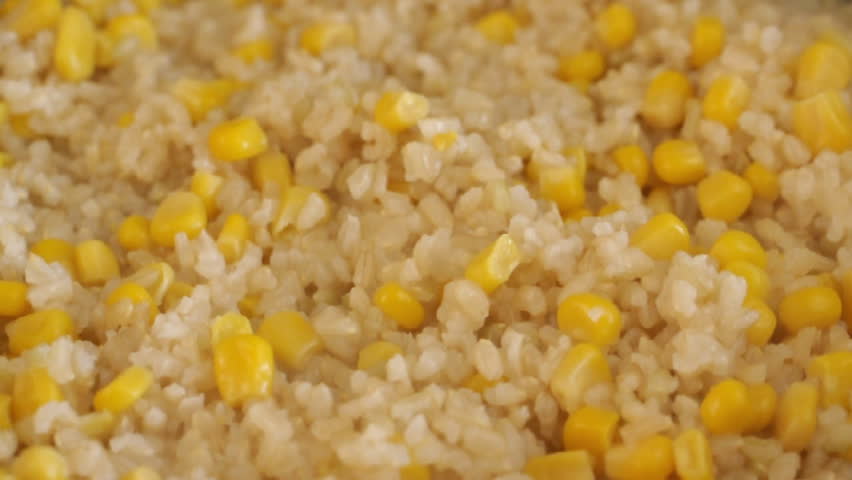 Closeup of cooking and stirring rice and corn
