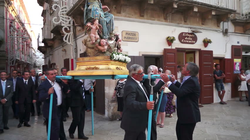 MARTINA FRANCA, ITALY - AUGUST 15: The marching band escorts the traditional Procession of Our Lady of the Assumption, followed by the Christian population parading through the city streets on August 15, 2012 in Martina Franca, Italy.