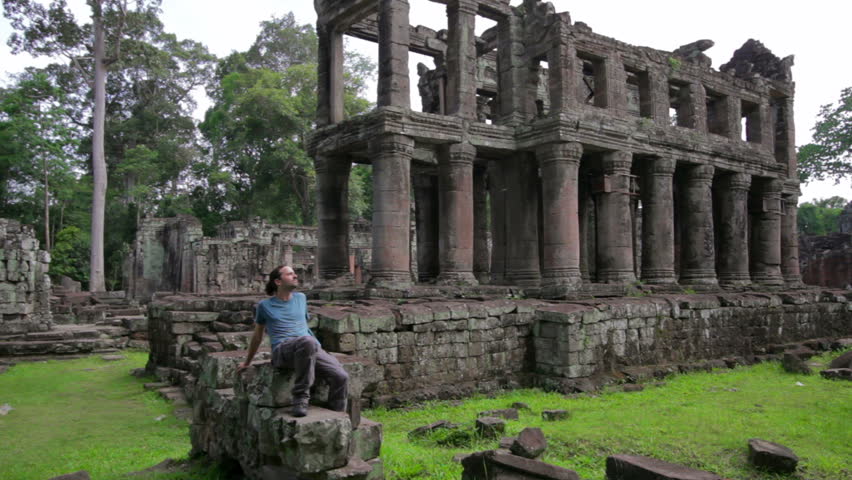 Backpacker sitting in preah khan temple, Angkor, Cambodia
