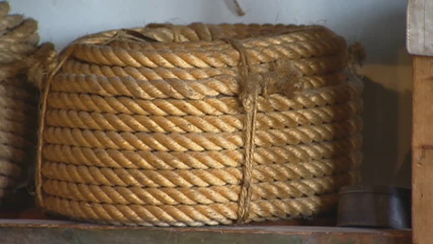 ENKHUIZEN ZUIDERZEEMUSEUM, THE NETHERLANDS - JULY 2003: traditional rope-maker's stockroom - extreme close up coiled rope shelves