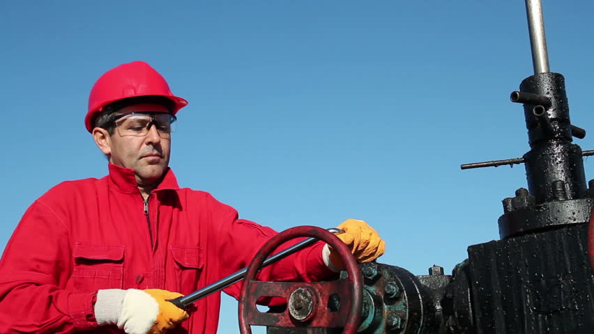 Oil Rig Valve Technician at Work
Worker in action at pump jack oil well. HD1080p. Canon EOS 600D.