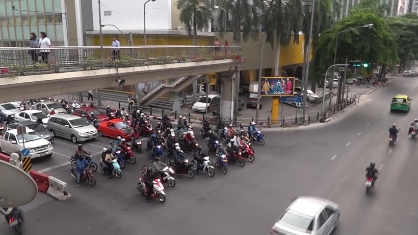 BANGKOK - AUGUST 27: Scooters are waiting for green light in Bangkok August 27, 2012 in Bangkok, Thailand.