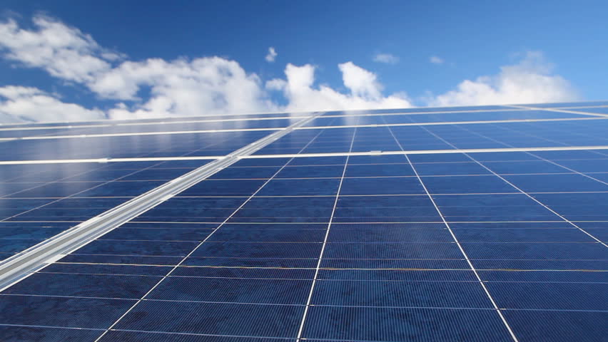Time-lapse of moving clouds over solar photovoltaics panels field for renewable energy production