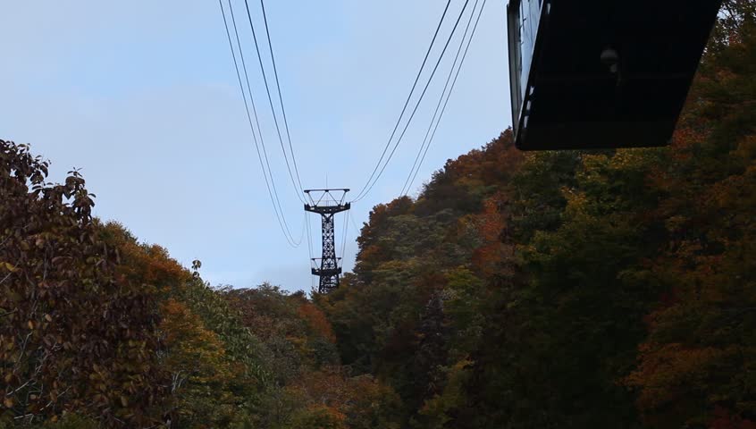 AOMORI, JAPAN - OCT 25: Gondola of Hakkoda ropeway climbing up to the summit of Mt.Hakkoda on October 25, 2012 in Aomori prefecture, Japan. This ropeway offering view of crimson foliage in autumn.