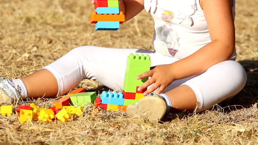 Building with plastic bricks

Description: Little girl building a house with plastic bricks      
