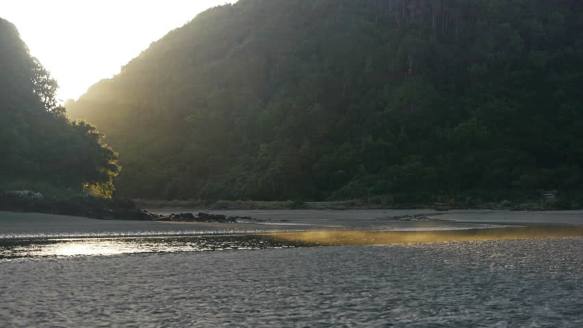 Mysterious sunrise peeks through hidden valley on Chiloe island in Chile