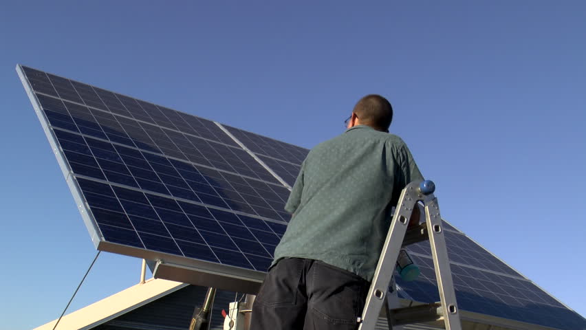 Time Lapse, Homeowner maintains backyard solar panel, wipes surface clean. blue sky background. 1080p