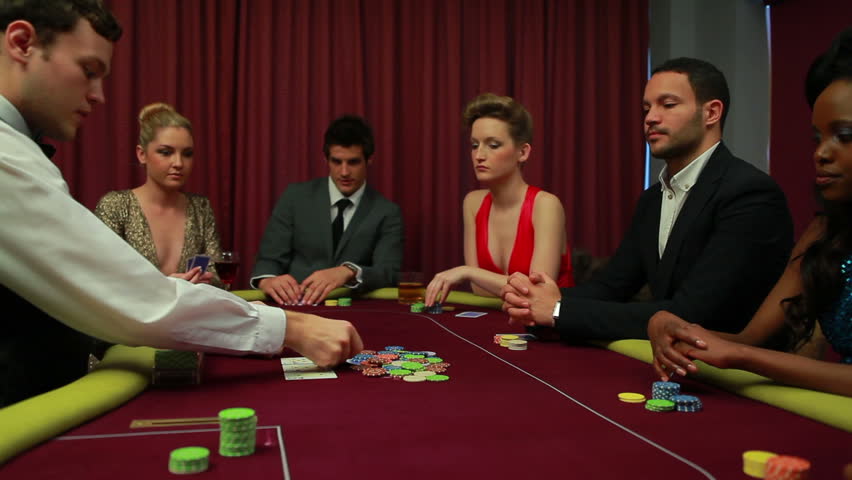 Dealer dealing poker cards and bets are being placed in casino