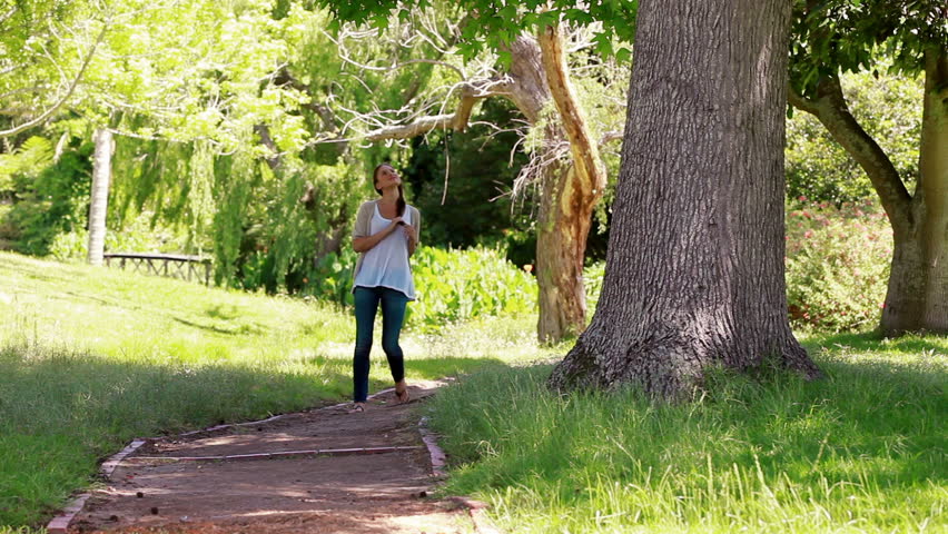 Woman walking on a footpath in a park