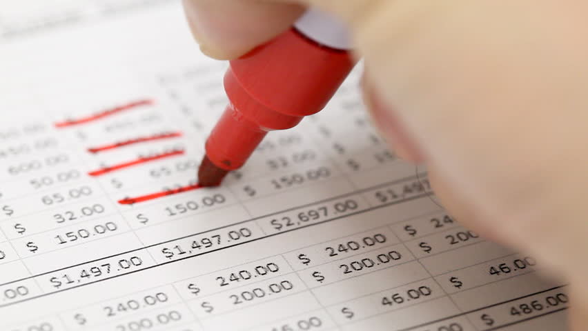 Man checking household budget numbers - money saving concept