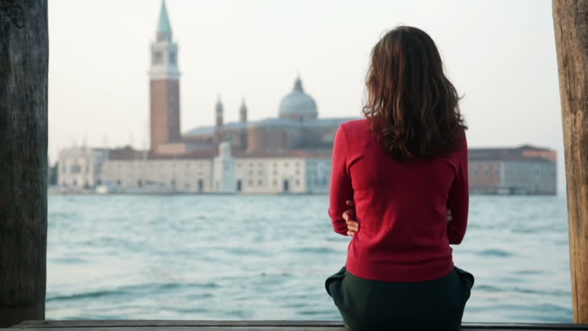 Lonely girl on a pier in Venice