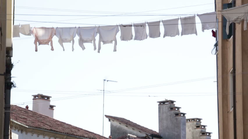 White clothes hanging on a rope drying in Venice