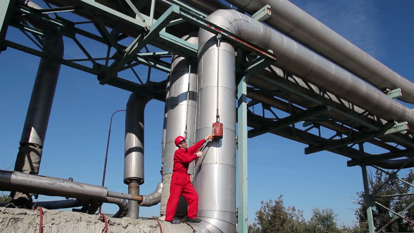Working on Pipelines in Power Plant.
Industrial worker in red overalls working on pipelines. HD1080p. 
