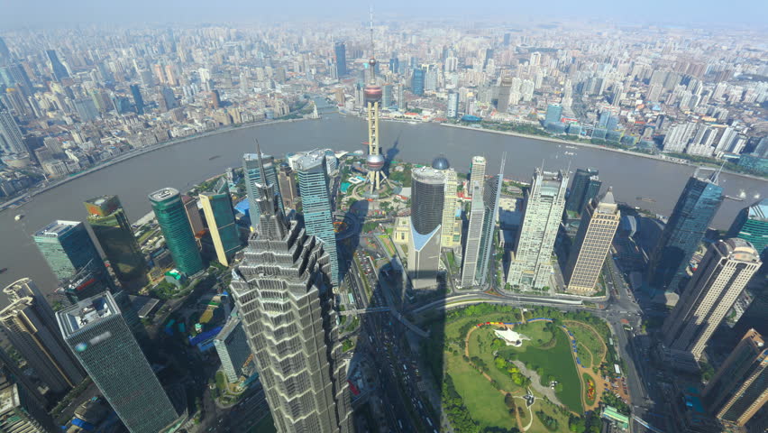 Shanghai, Time-Lapse. Elevated view of high-rise buildings with river in Shanghai, China. Jin Mao Tower (one of China's tallest buildings) and Oriental Pearl Tower.