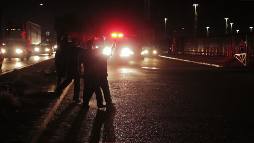People on the street stopping the ambulance because of the accident by night
