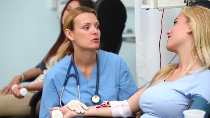 Nurse checking the monitor of a patient in hospital ward