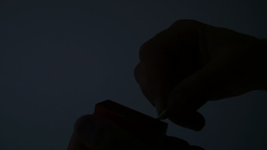 Lighting a match slow motion. Close Up.