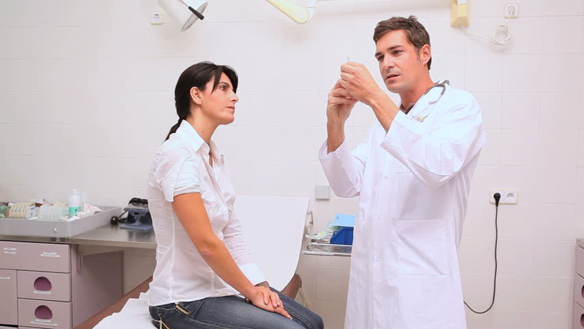 Videos of a doctor preparing a syringe and disinfecting arm of a patient in examination room