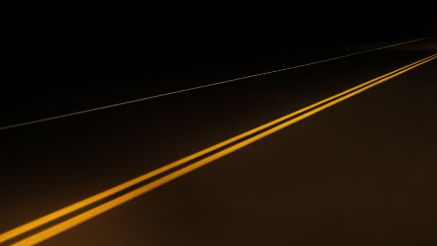Driving at night on a rural road. Yellow lines and approaching car at end of clip. Ontario, Canada.
