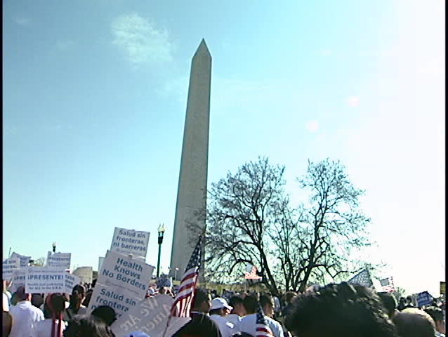 WASHINGTON, DC - APRIL 10: Marching to National Mall for immigration reform rally during national  March for America on April 10, 2006."Justice for immigrants now" placard passes.
