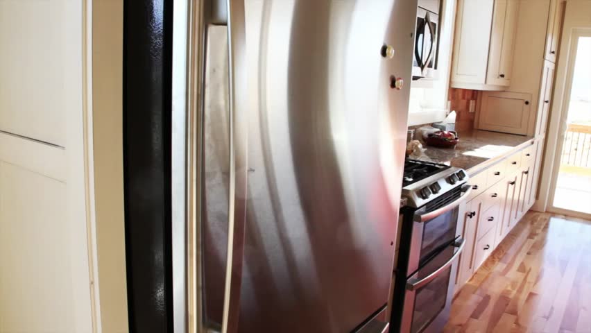 A man takes milk out of the fridge