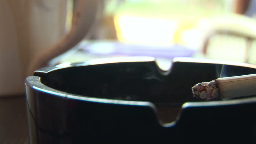 Cigarette and ashtray on a table 
