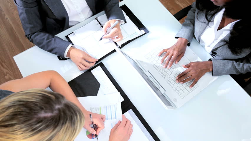 Multi ethnic business female closing deal with handshake