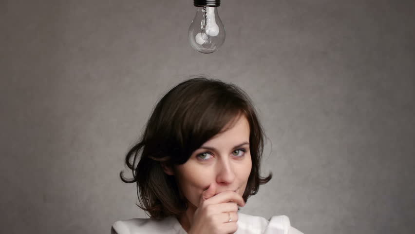 pensive woman gets an idea, which lights up a symbolic lamp over her head