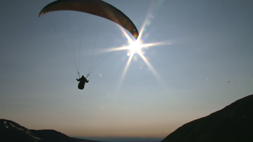 Almost like floating in space, a paraglider moves smoothly through the air, floating on thermals above the mountains at Hatcher Pass, Alaska.