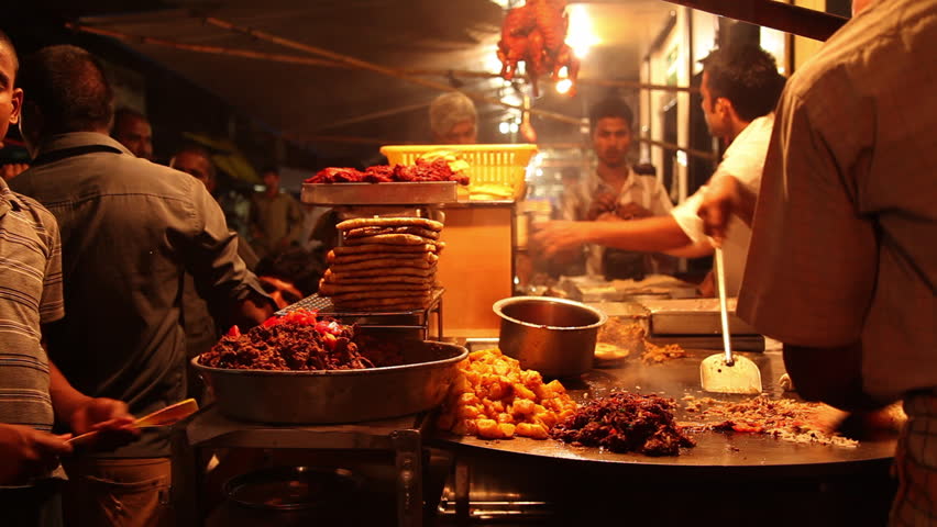 INDIA - JULY 2012: Locked-on shot of a chefs preparing food, Khau Galli, Mumbai, Maharashtra, India