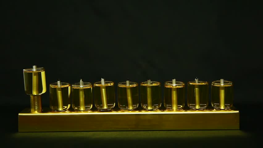 Lighting a Hanukia made of olive oil lanterns time lapse