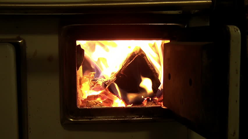 Slow motion fire in furnace with opened doors 
