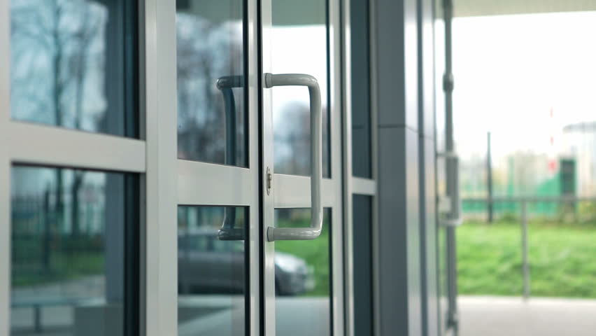 Girls come into glass doors of the building