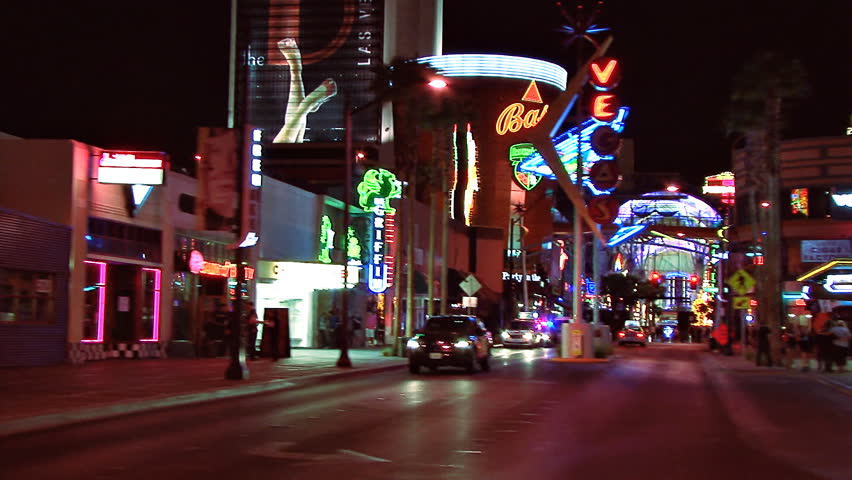 LAS VEGAS, NV - CIRCA 2012: Side view from moving auto - tracking shot from close indistinct building side to party time Las Vegas lights