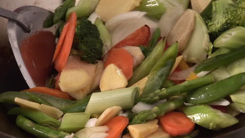 Stir-frying vegetables in a wok