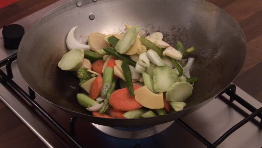Stir-frying vegetables in a wok