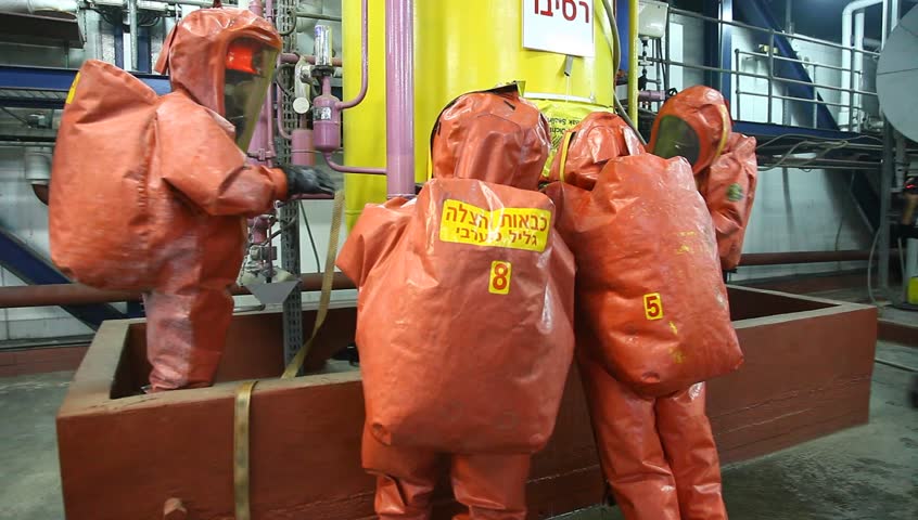 NORTHERN ISRAEL -DECEMBER 17: Firefighters practice to remedy leak accident of corrosive toxic hazardous material Ammonia liquid in seven food factories using protective suites, Northern Israel December 17 2012