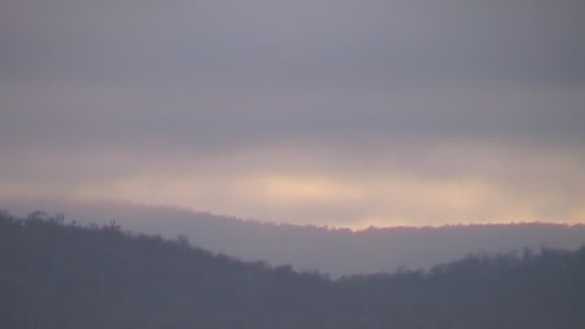 Time lapse footage of early morning over the mountains