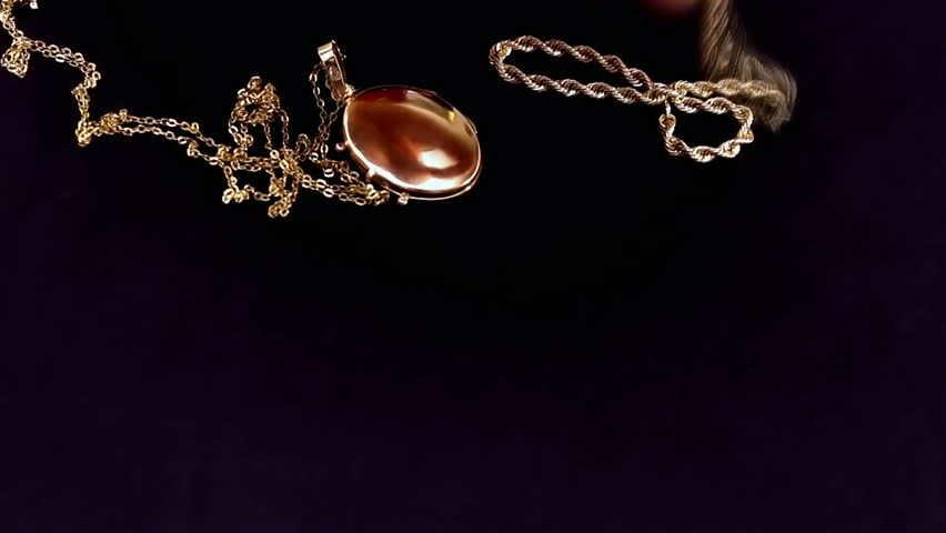 gold jewelry on black pleat Young woman arrange wonderful gold jewelry on black pleat, video clip,