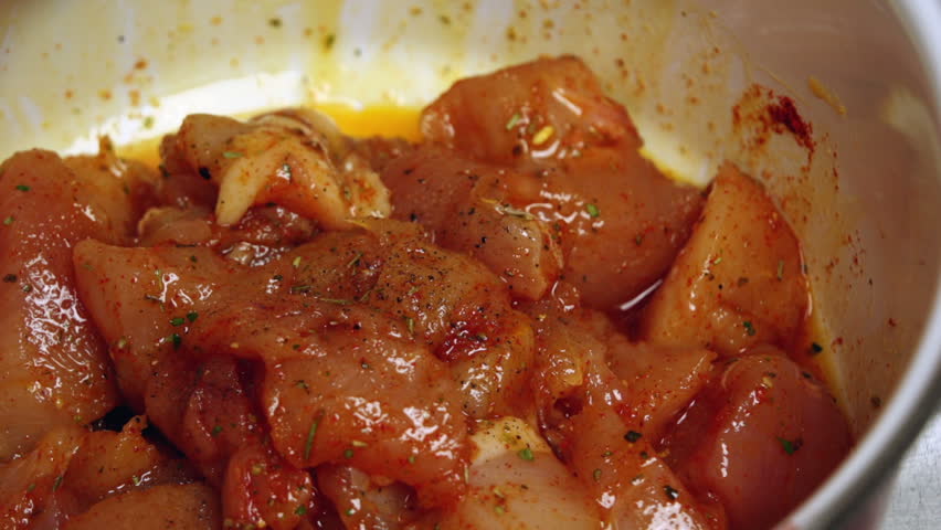 Super 35mm camera - seasoning chicken meat and mixing it by hand