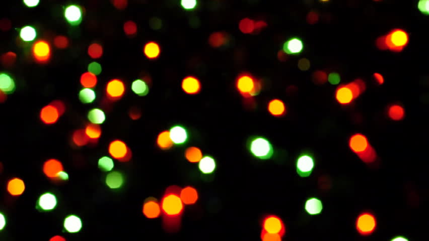 Blurred colorful Christmas lights on black background with varying fade and twinkle patterns