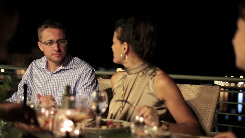 Friends eating dinner in the evening, stabilized shot