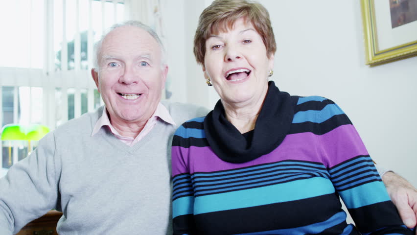 An elderly couple are video chatting with loved ones via their computer. Shot from the p.o.v. of the computer screen