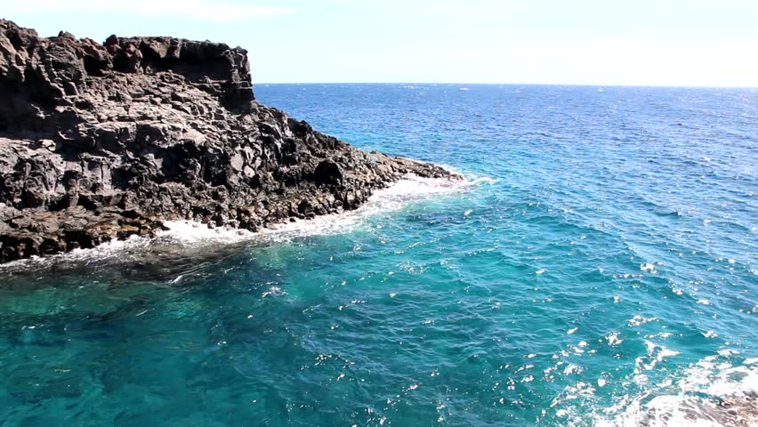 Tenerife, Canary Islands, Spain - beautiful basalt rock coast of Playa Amarillo with crashing waves. Full HD resolution clip.